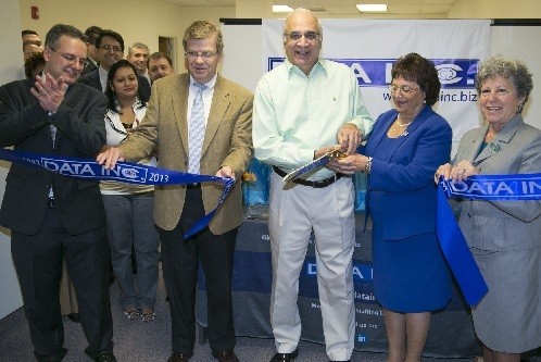 Photo: DATA Inc. CEO Arun Verma and Edison Mayor Antonia Ricigliano (sharing scissors) handle the ribbon cutting to open DATA Inc.'s new office in Edison, N.J. Also pictured Edison Chamber of Commerce president Barbara Roos (far right), DATA Inc. marketing director George Nikanorov (far left) and Leo Mennitt, vice president at the New Jersey Technology Council. Photo Credit: Clark Jones