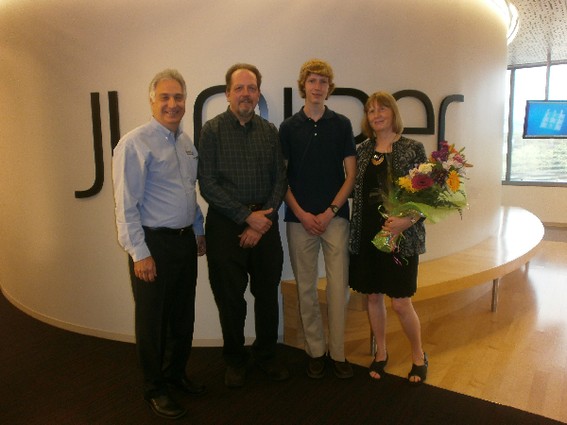 Photo: Ian Lawson with Jerry Passione, general manager of Juniper OpenLab and Lawson's mother and father. Photo Credit: Courtesy Juniper OpenLab