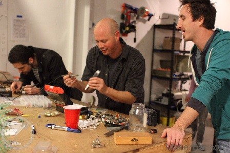 Photo: Two of MakerBar's Founders, Zack Freedman on the left and Matt Williams (middle) working on an electronics project. Rich Jedrzejek (on right) looking on.
  Photo Credit: Jonn Robinet