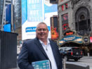 Dean Guida with his book in Times Square