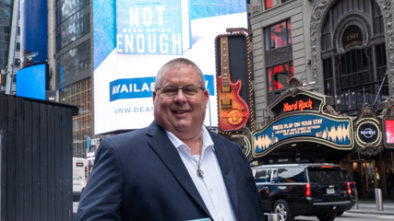 Dean Guida with his book in Times Square